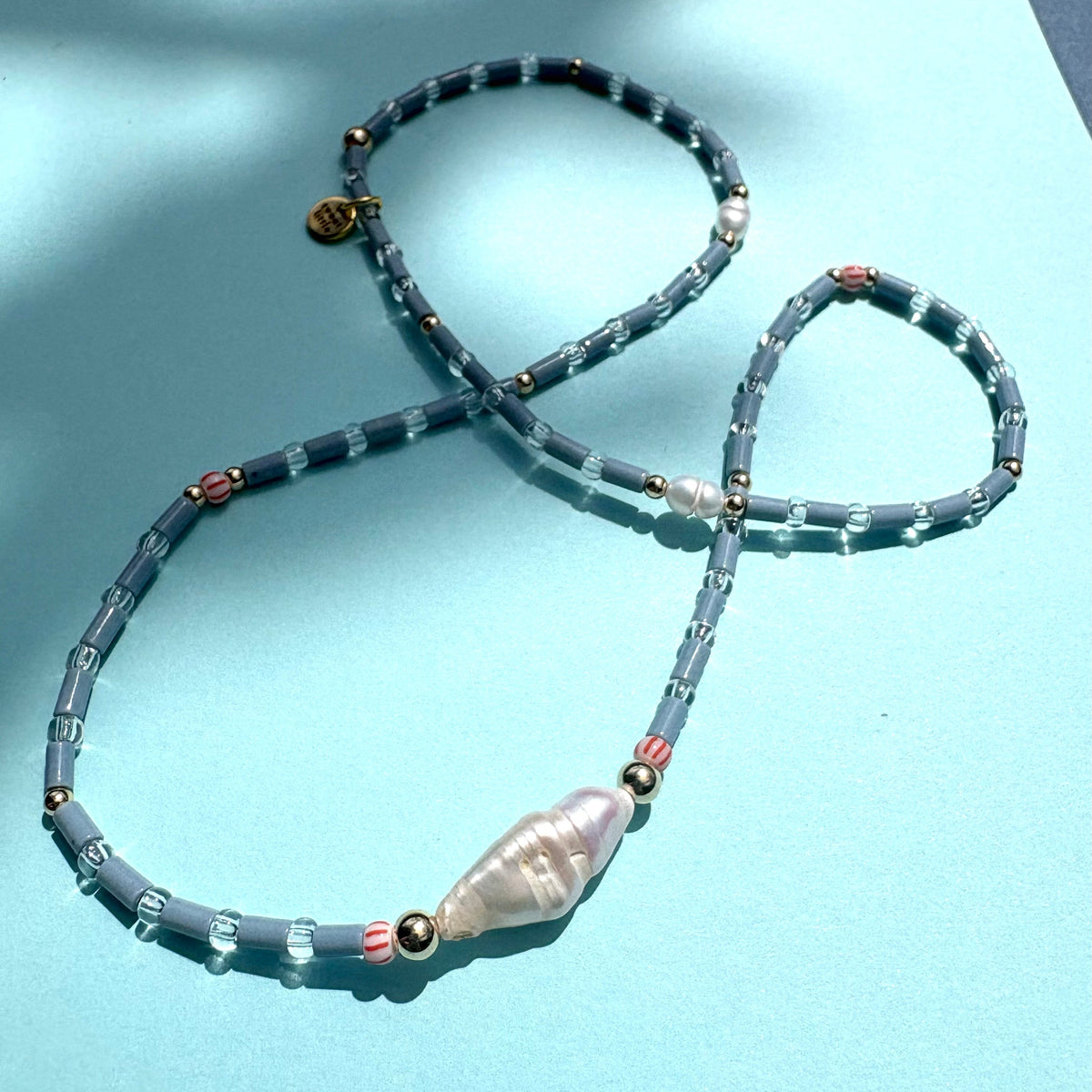 Fine blue tube bead necklace with stick pearl