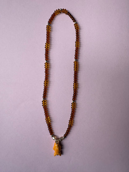 Browns and gold glass beaded necklace with repurposed orange fish charm