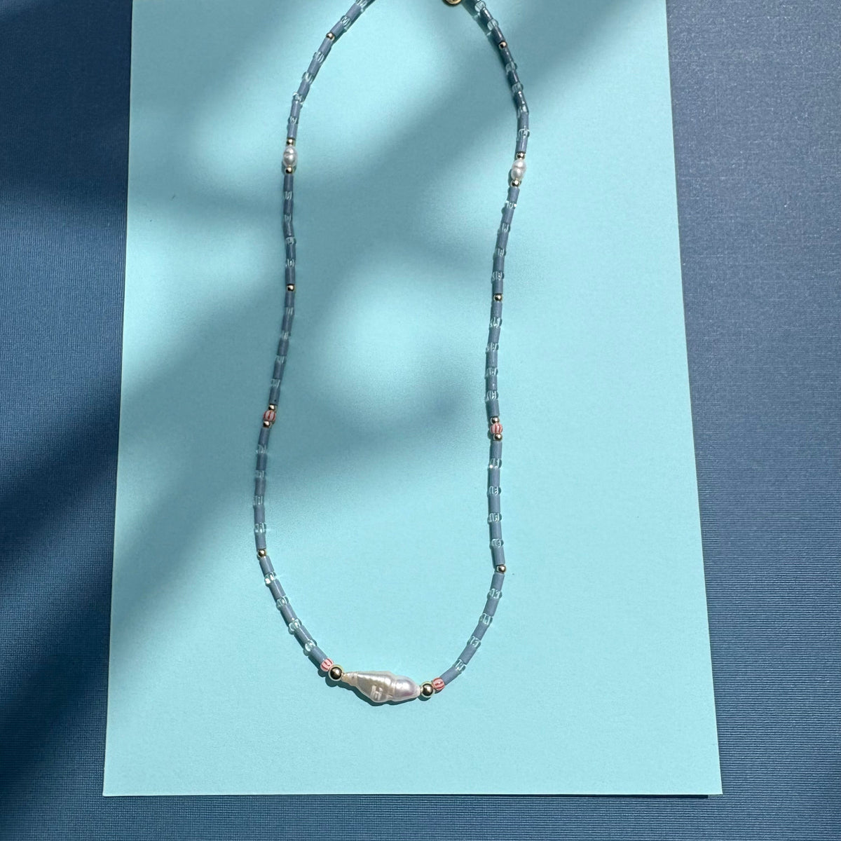 Fine blue tube bead necklace with stick pearl