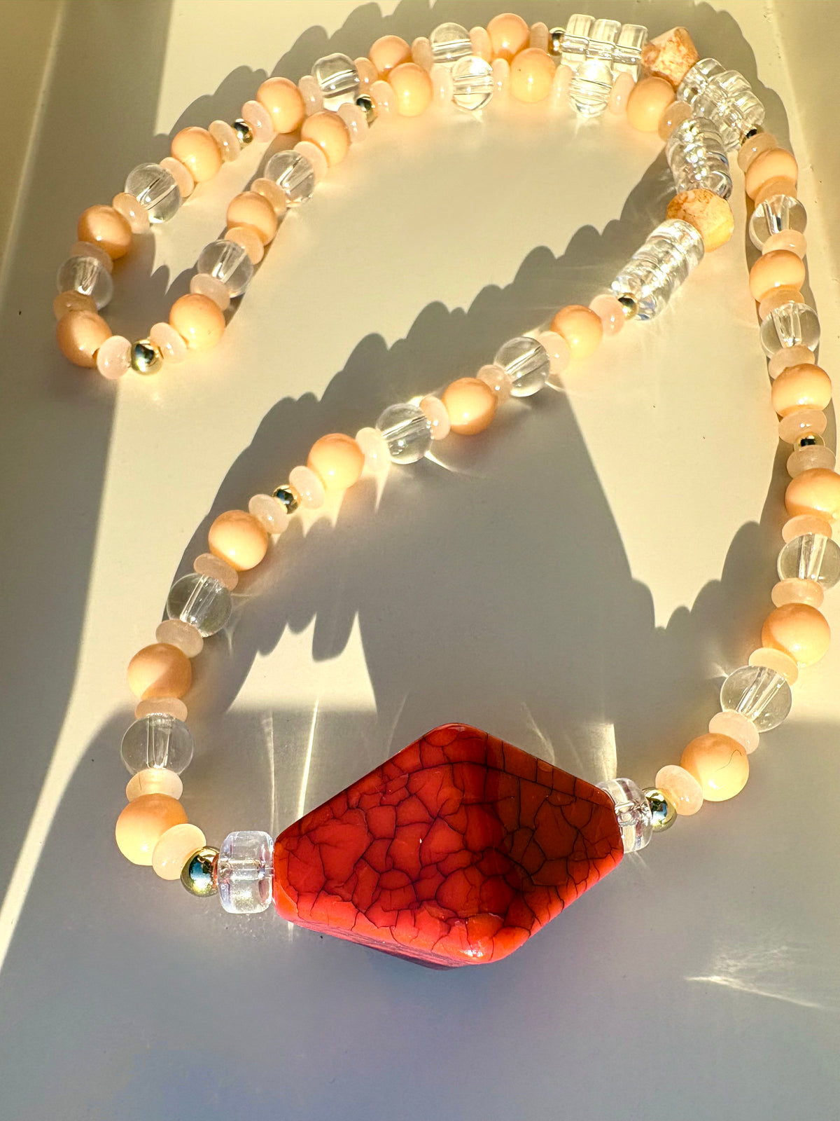 Peachy, glass beaded necklace with red geometric centerpiece