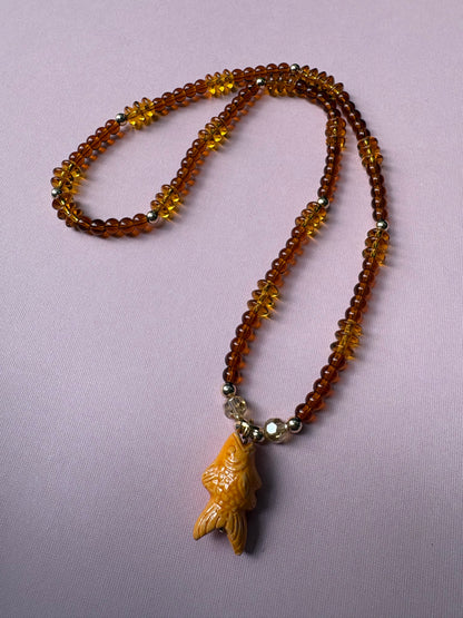 Browns and gold glass beaded necklace with repurposed orange fish charm