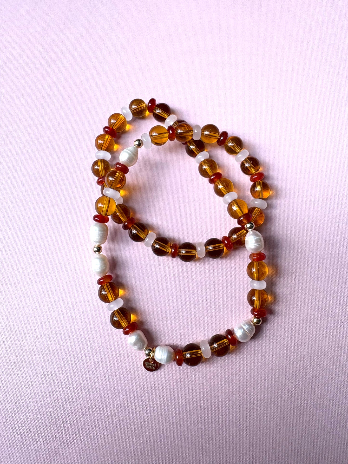 Browns and golds glass beaded necklace with freshwater pearls.