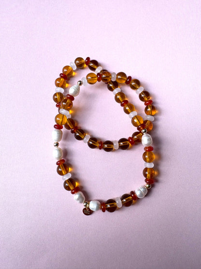 Browns and golds glass beaded necklace with freshwater pearls.