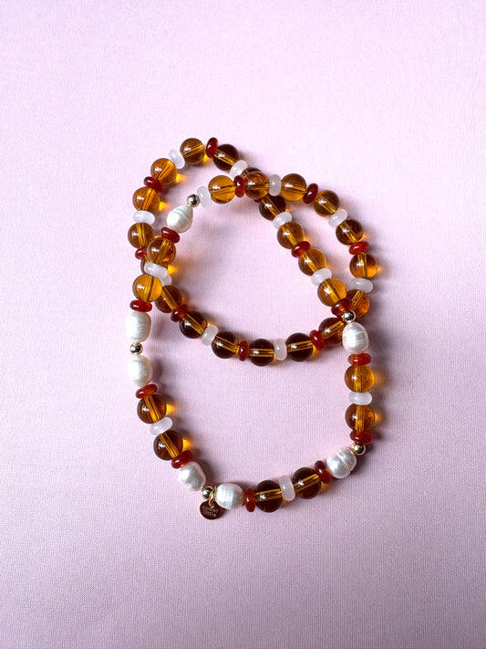 Browns and golds glass beaded necklace with freshwater pearls.