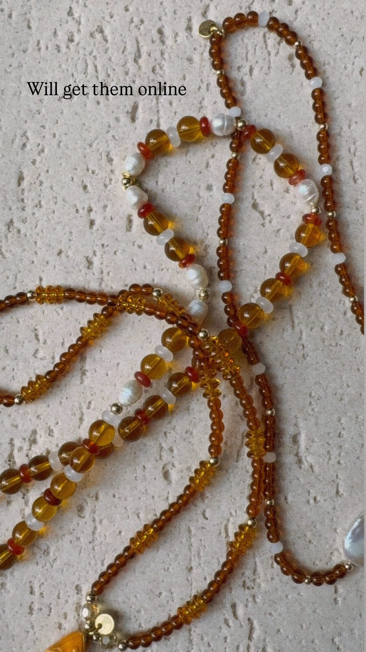 Browns and golds glass beaded necklace with freshwater pearls.