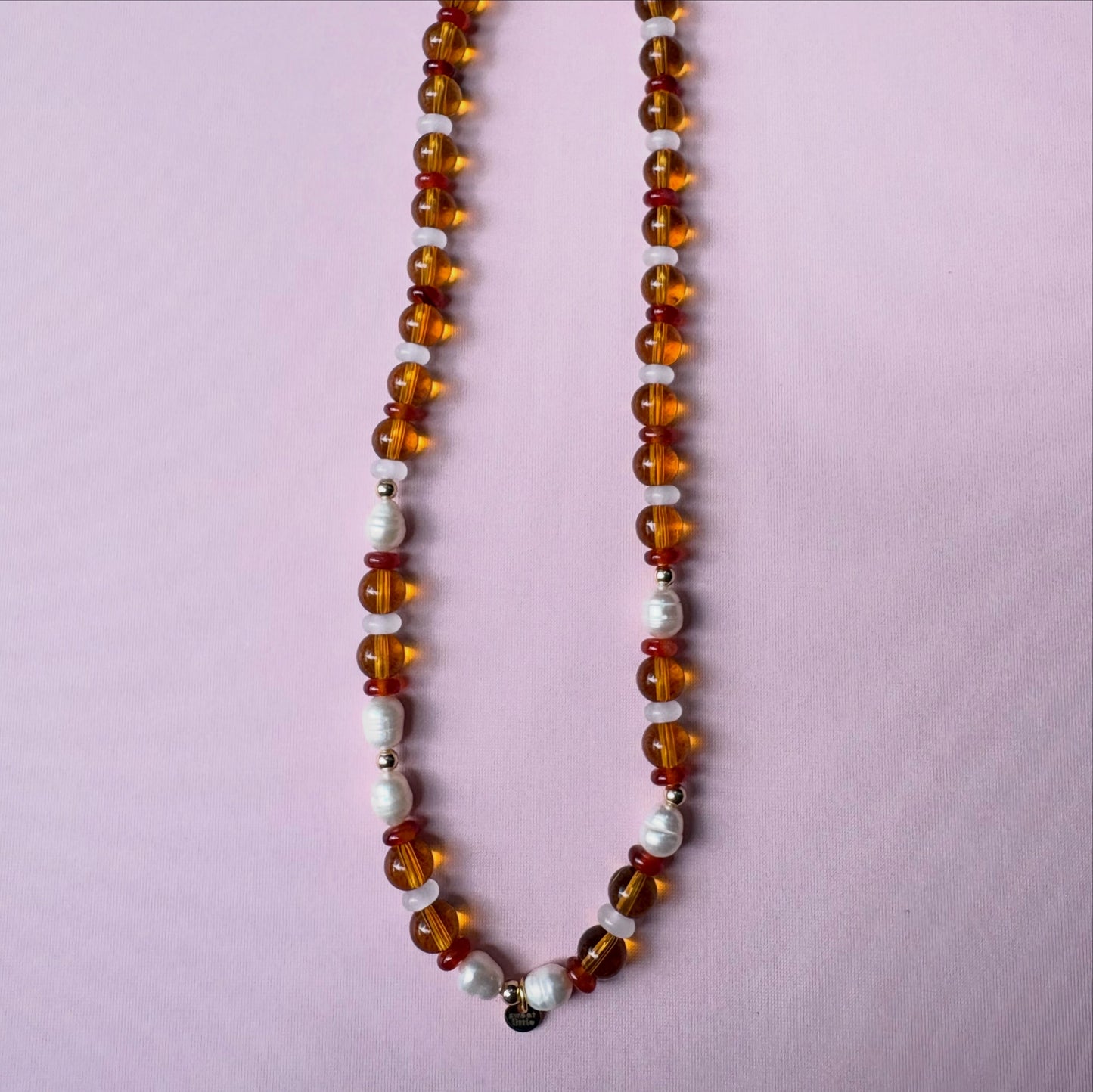Browns and golds glass beaded necklace with freshwater pearls.