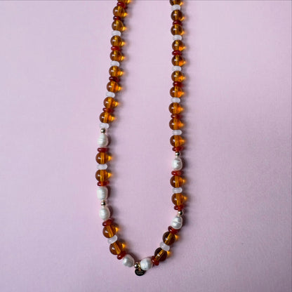 Browns and golds glass beaded necklace with freshwater pearls.