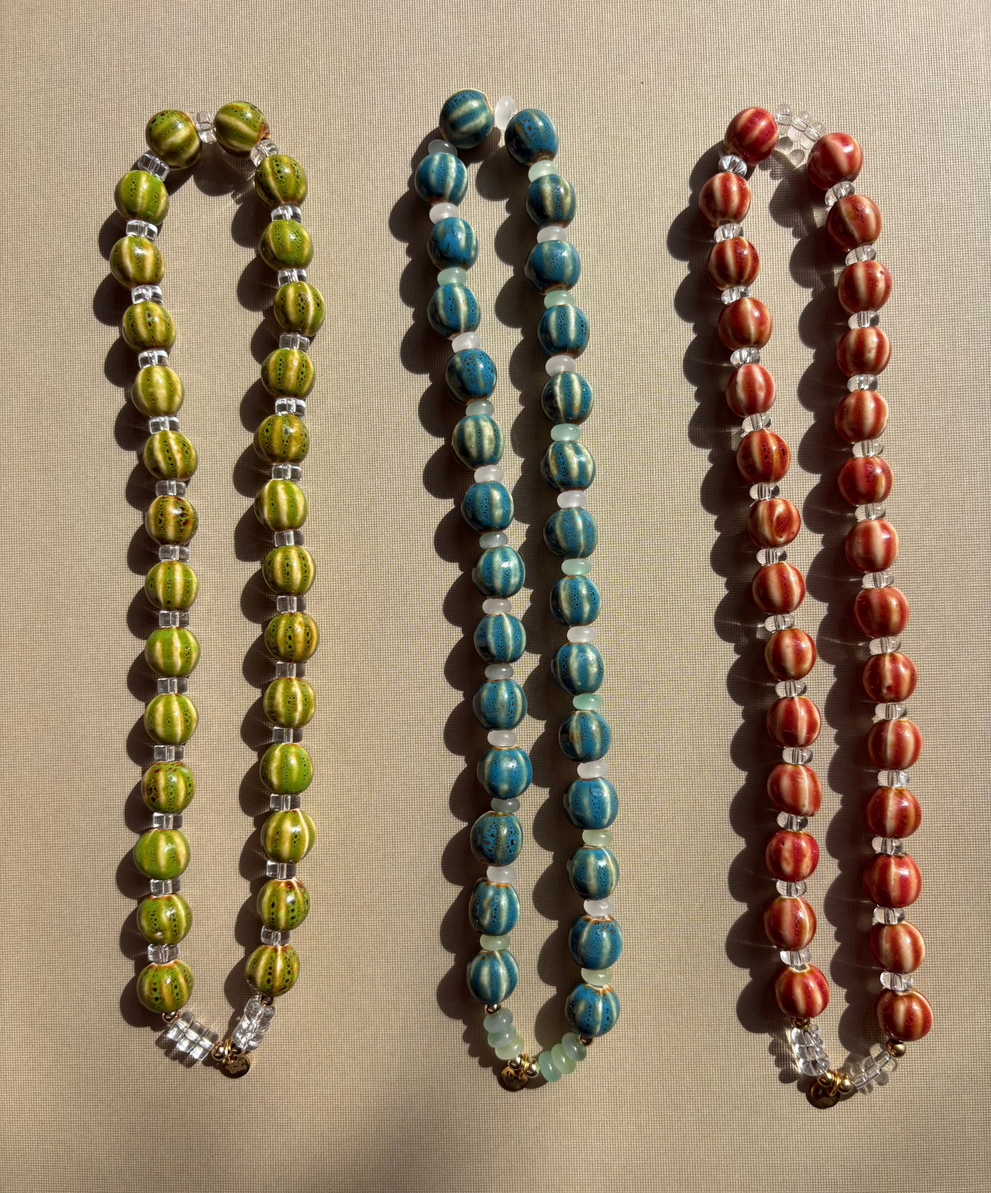 Striped ceramic and glass beaded necklaces