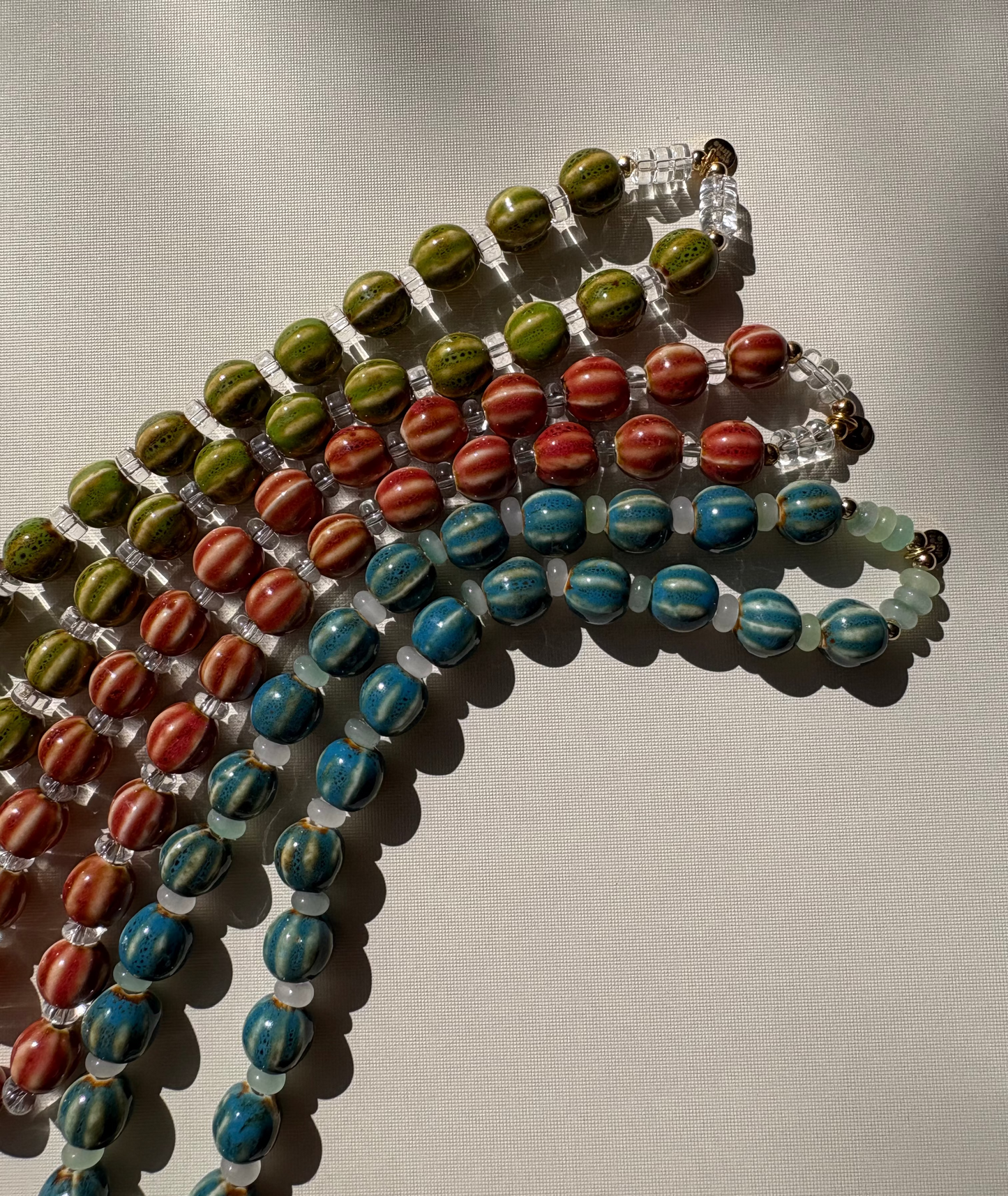Striped ceramic and glass beaded necklaces